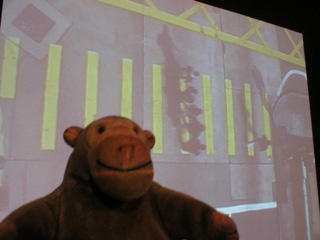 Mr Monkey watching footage of five people crossing a zebra crossing