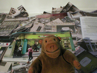 Mr Monkey looking at the cut out Lee Tung Street apartments and shops