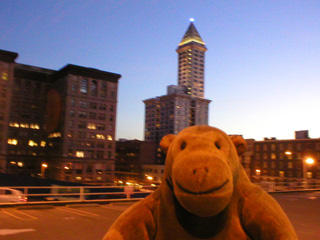 Mr Monkey looking towards Smith Tower at dusk