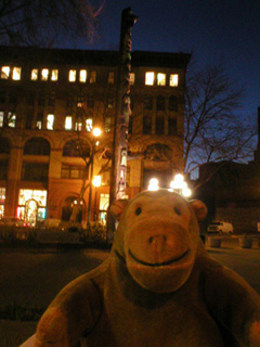 Mr Monkey looking at the totem pole in Pioneer Square