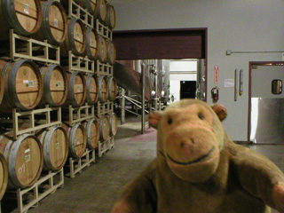 Mr Monkey looking at barrels inside the Columbia Winery