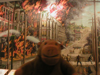 Mr Monkey looking at a mural of the Great Fire