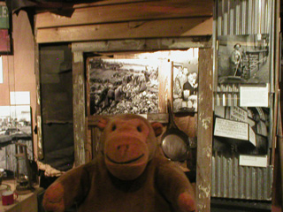 Mr Monkey looking at a replica Hooverville shack