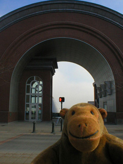 Mr Monkey looking at the Washington State History Museum archway to the Bridge of Glass