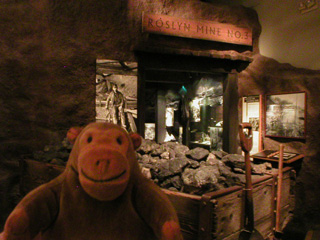 Mr Monkey looking at the entrance to a coal mine