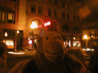 Mr Monkey on a Pioneer Square street at night