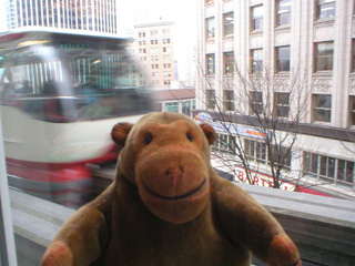 Mr Monkey watching the monorail from the Westlake Center's food court