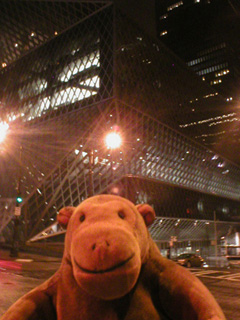 Mr Monkey looking Seattle Central Library at night