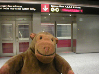 Mr Monkey in front of the internal transfer train at SEA-TAC