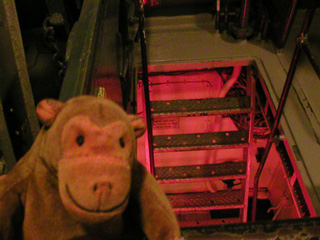 Mr Monkey looking at a hatch and steps down to the forward boiler room