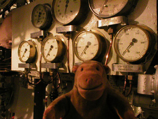 Mr Monkey looking at a set of pressure gauges in the forward boiler room