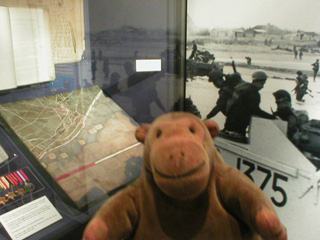 Mr Monkey looking at a display about the Normandy landings