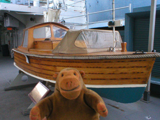 Mr Monkey looking at a 16' Fast Motor Boat
