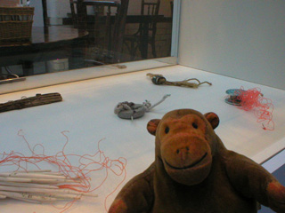 Mr Monkey looking at bits of Manx beach debris