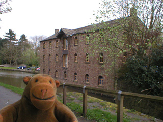 Mr Monkey looking at the side of Samuel Oldknow's warehouse