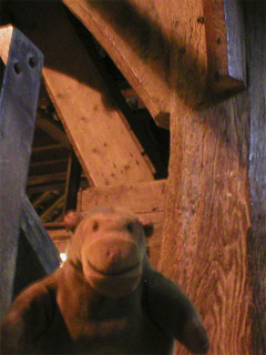 Mr Monkey examining oak beams supporting the mill
