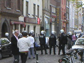 The back of a line of rather casual riot police