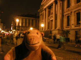 Mr Monkey beside the Bourse at night