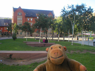 Mr Monkey looking at Chethams college across the Millenium Gardens