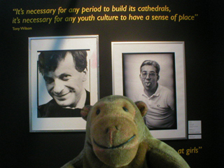 Mr Monkey looking at photos of Tony Wilson and Rob Gretton