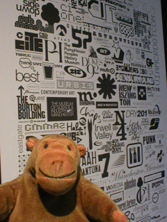 Mr Monkey looking at examples of typography by Trevor Johnson