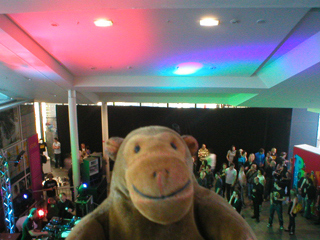 Mr Monkey looking at the coloured lights shining on the Urbis ceiling