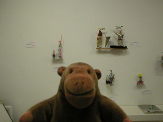 Mr Monkey looking at a display of Lucy Casson sculptures with his purchase removed