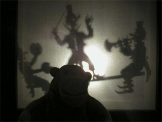 Mr Monkey watching clown shadow puppets