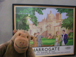Mr Monkey looking at an LNER poster for Harrogate
