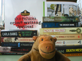 Mr Monkey at the books his humans bought at Harrogate