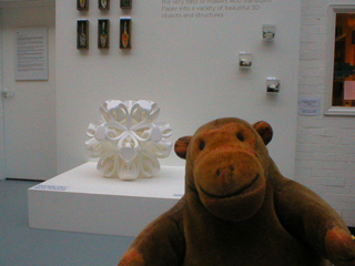 Mr Monkey looking at a paper sculpture by Richard Sweeney