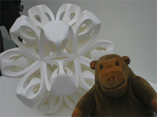 Mr Monkey inspecting a paper sculpture by Richard Sweeney