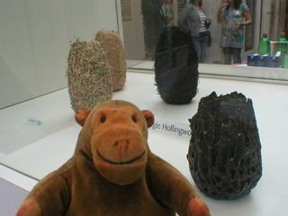 Mr Monkey looking at vases by Magie Hollingworth