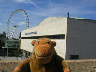 Mr Monkey looking at Event Horizon figures on top of the Royal Festival Hall