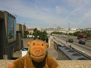 Mr Monkey looking down on the Gormley figure on Waterloo Bridge