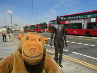 Mr Monkey looking at a Gormley on Waterloo Bridge