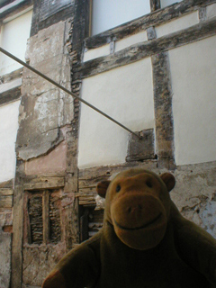 Mr Monkey looking at the exposed interior of the wall of the north wing