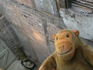 Mr Monkey looking down at the outside wall of the north wing