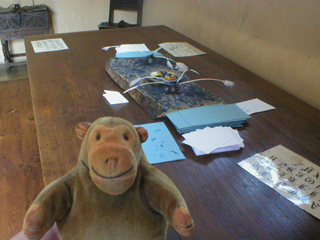Mr Monkey looking at the large table in the counting house