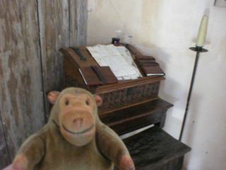 Mr Monkey looking at a writing desk