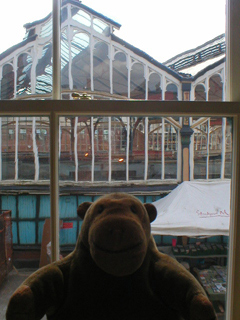 Mr Monkey looking at Stockport market hall from the 19th century parlour