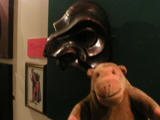 Mr Monkey looking at a Commedia del'Arte mask