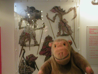 Mr Monkey looking at Javanese shadow puppets