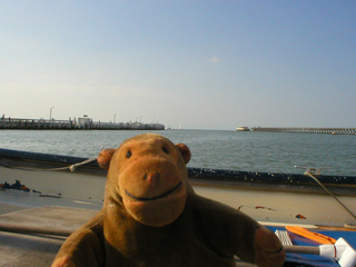 Mr Monkey looking at the mouth of Ostende harbour from the Blue Link Overzet ferry