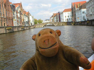 Mr Monkey travelling up the Spiegelrei after looking at the back of Jan Van Eyck