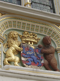A carving of the arms of Bruges supported by a lion and a bear