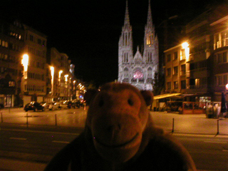 Mr Monkey looking at the St Peter and St Paul church in the dark