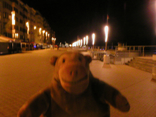 Mr Monkey walking along the promenade at night