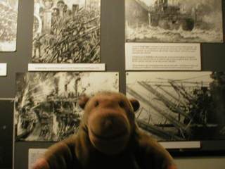 Mr Monkey looking at photographs of the Zeebrugge raid