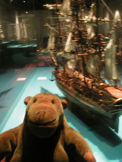 Mr Monkey looking at a model sailing ship